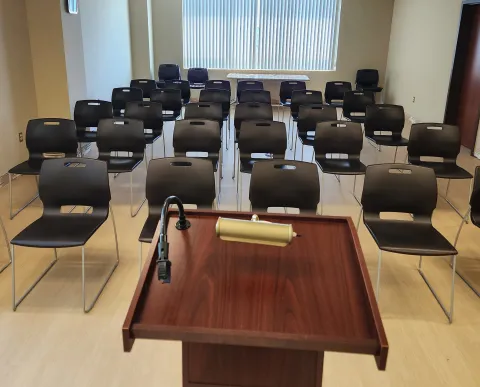 large room set up auitorium style with podium up front