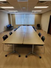 tables set together in the middle of the room like a large boardroom style setup